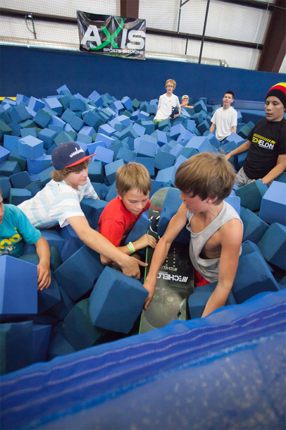 These kids are attempting another kind of board grab in the main foam pit.