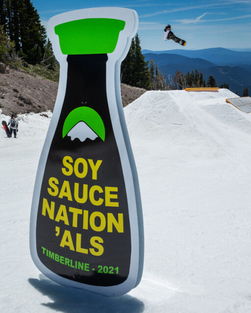 Bernardo Carandang snowboards behing a Soy Sauce Nation'als sign