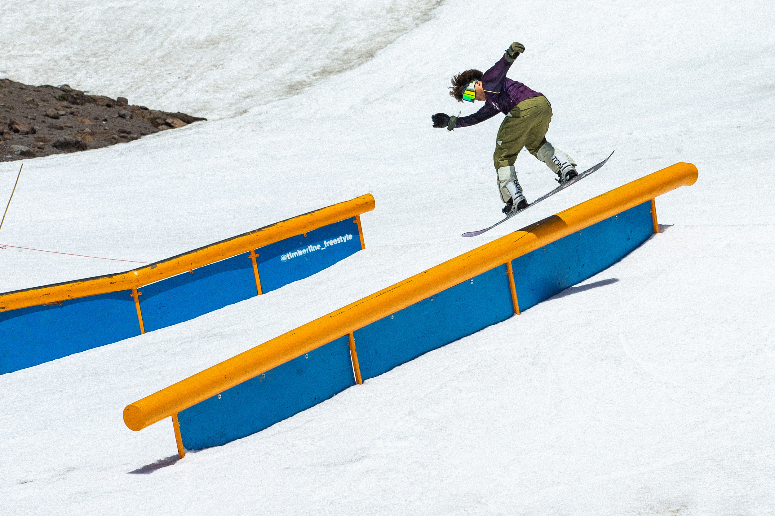 Raibu Katayama hits a rail on his snowboard