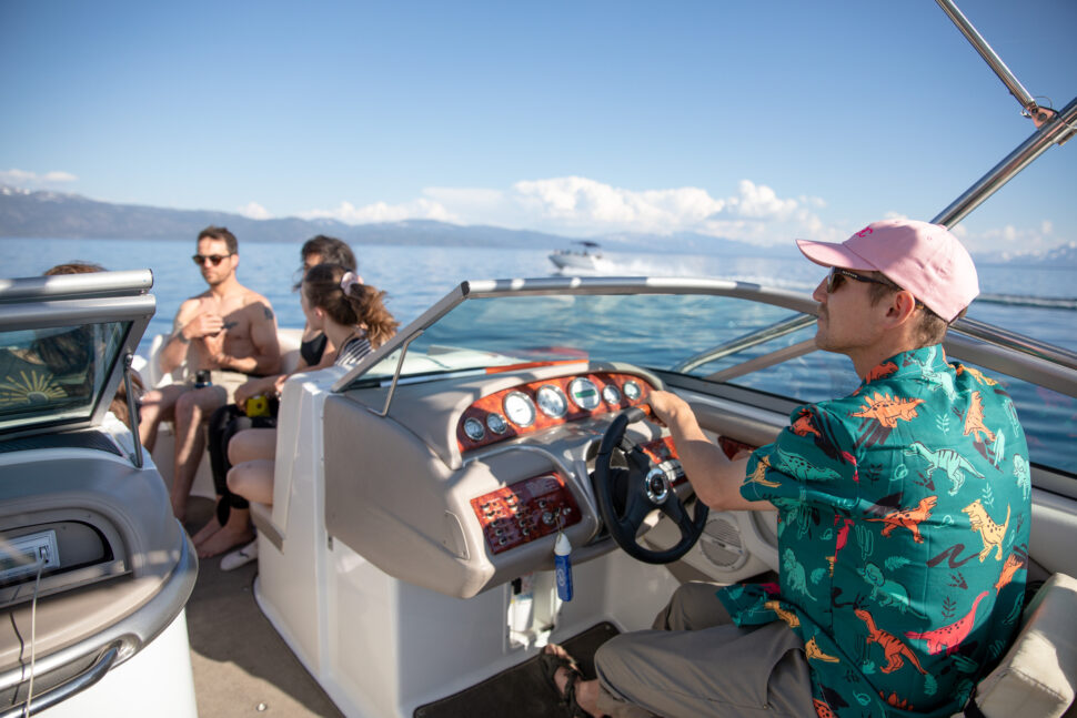Nial Romanek captaining a boat on Lake Tahoe